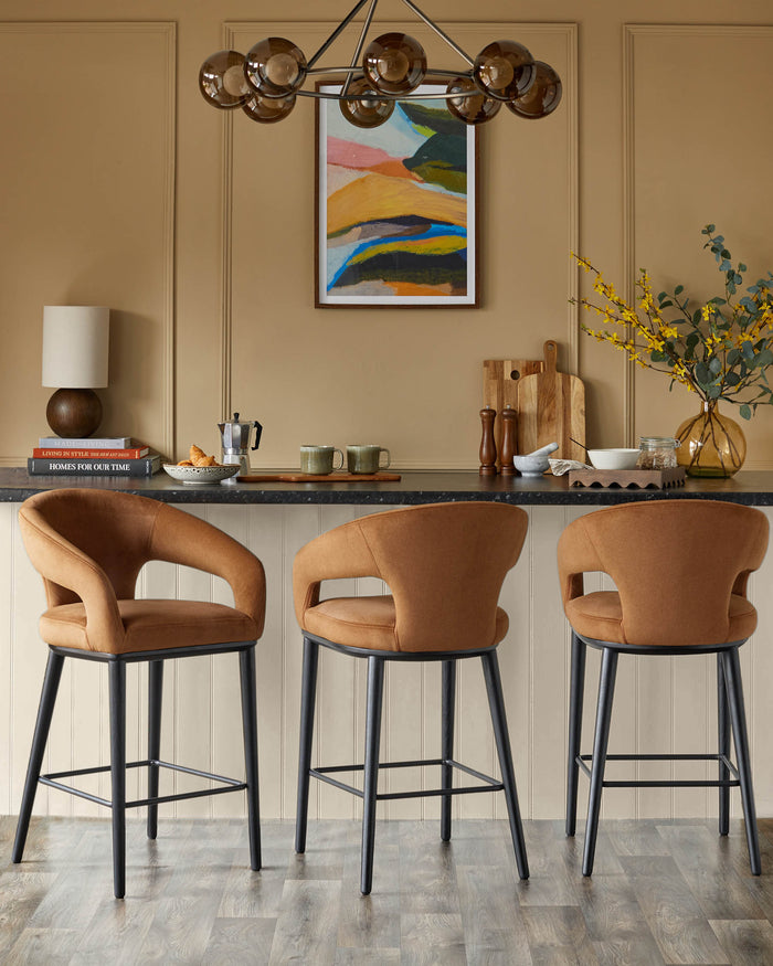 Three brown bar stools with black legs sit at a kitchen island, blending modern style with comfort.