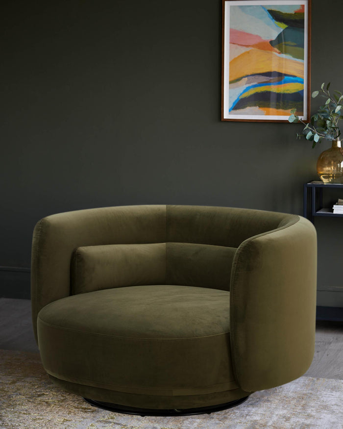 Stylish olive green velvet swivel armchair, with abstract art and dark shelving unit in the background.