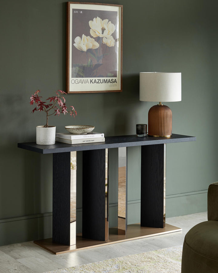 Contemporary console table with a sleek, dark top and mirrored accents, creating a stylish statement piece for modern interiors.