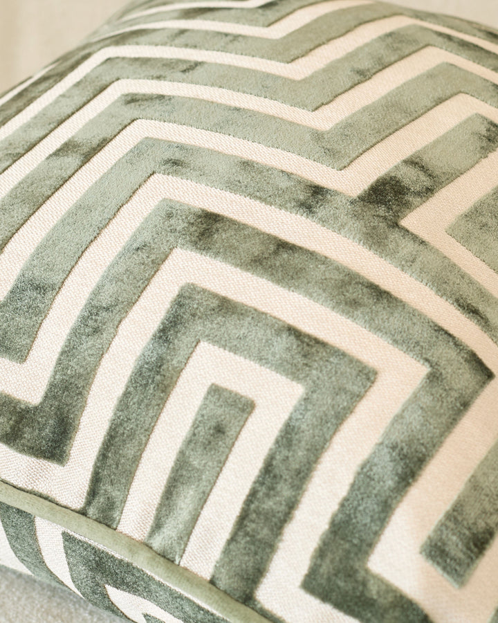 Imani cushion in medium olive green with cream geometric chevron pattern, close-up detail view.