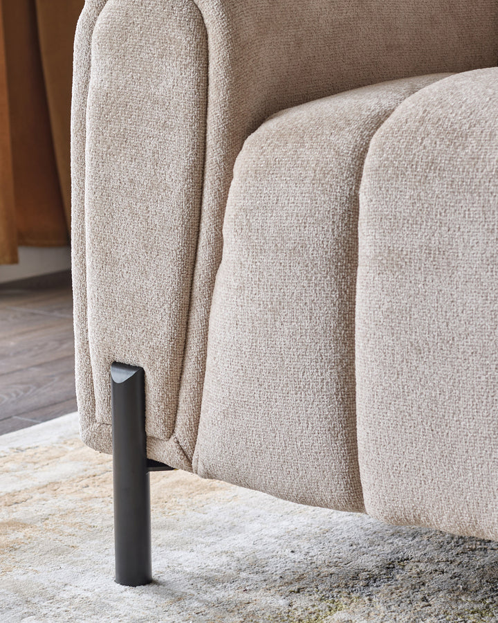 Kendra 3-seater sofa in natural fabric with curved arms and black metal leg detail, side view.