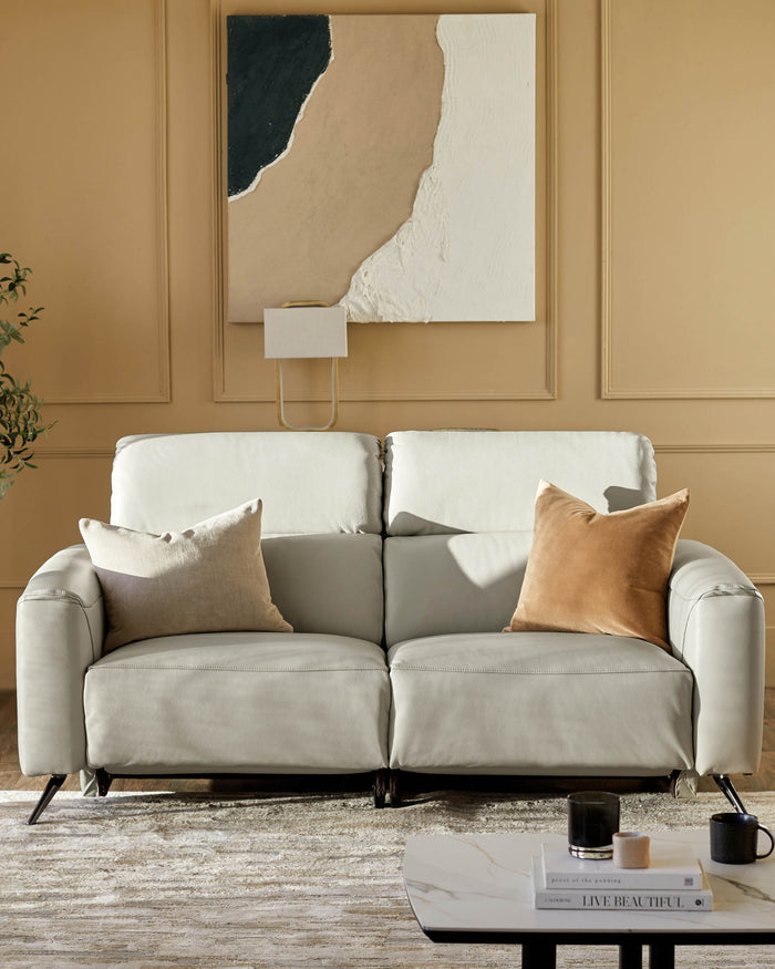 A stylish sofa takes centre stage, complete with cushions and a modern coffee table. The perfect living room set.