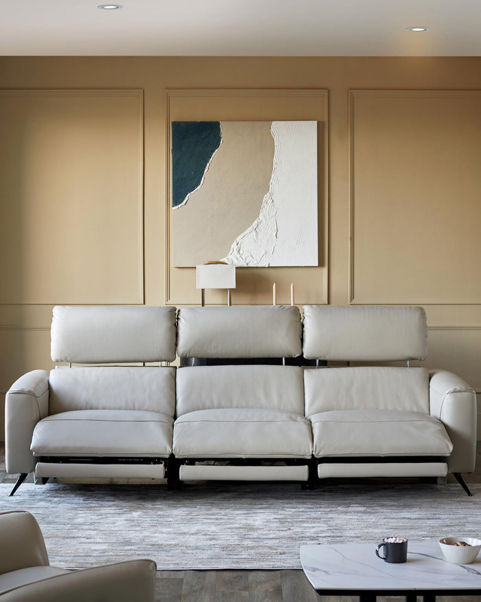 A luxurious recliner sofa sits atop a stylish rug, offering the perfect blend of comfort and modern design.