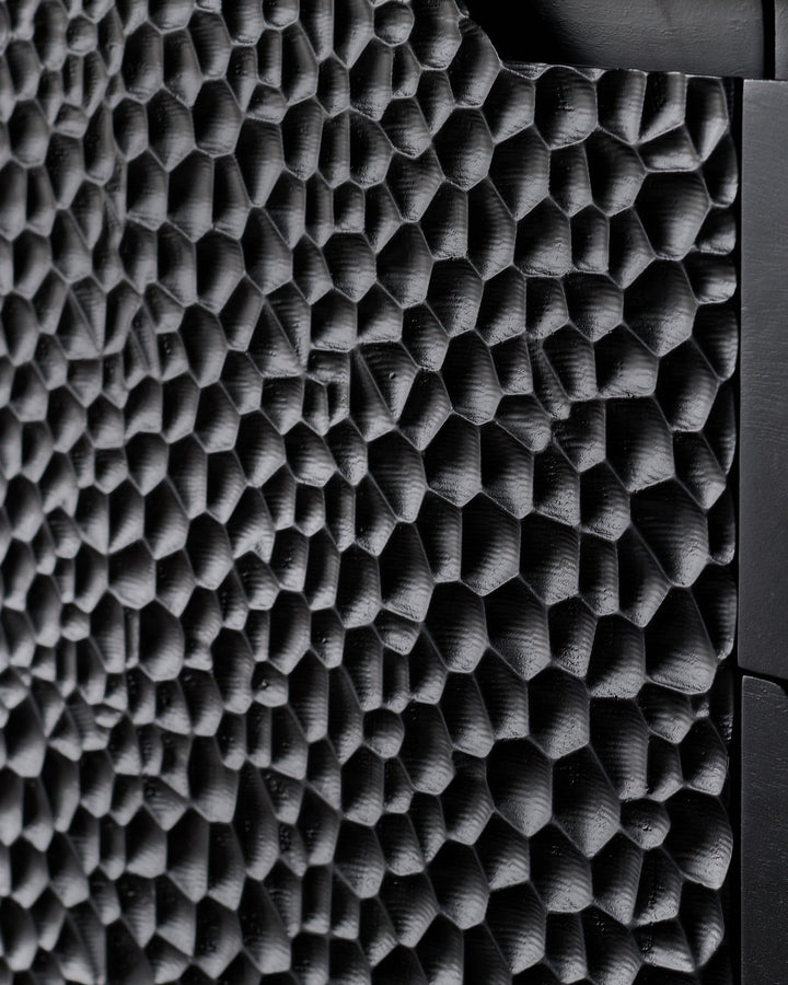 Close-up of Knox Large Sideboard's textured black wood surface showing geometric hexagonal relief pattern detail.