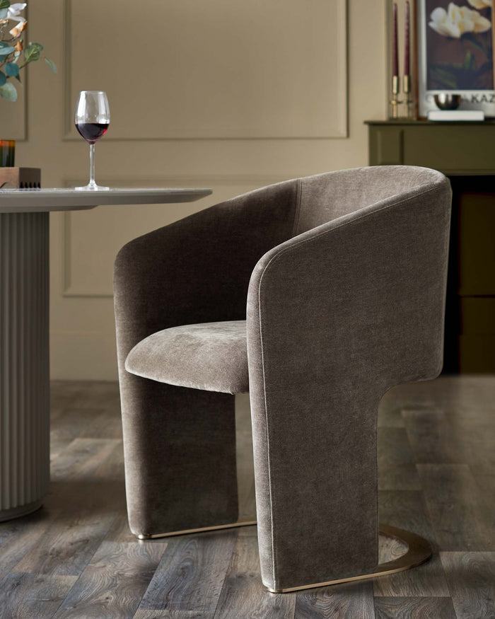 Stylish brown upholstered chair with a curved back and circular base at a round table, creating a luxurious dining space.
