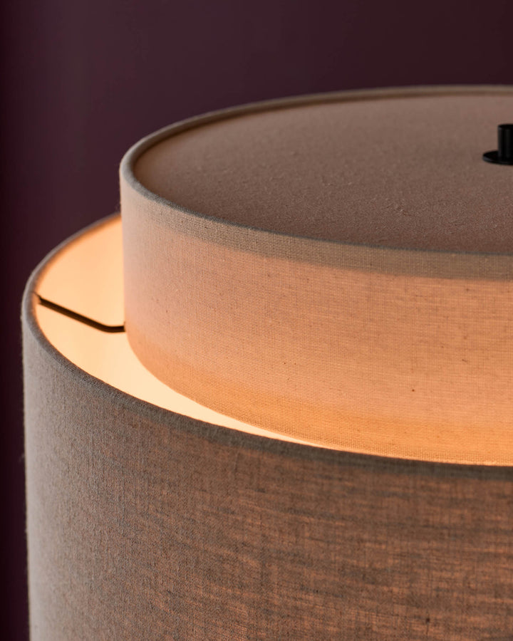 Leonie floor light with natural linen shade and mocha base, detail view showing warm interior glow and cylindrical shape.