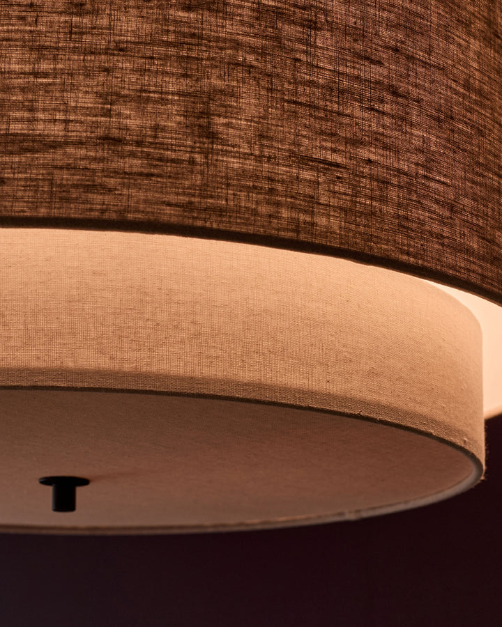Leonie pendant light with natural linen shade and mocha base, close-up detail view showing cylindrical fabric shade and fixture.