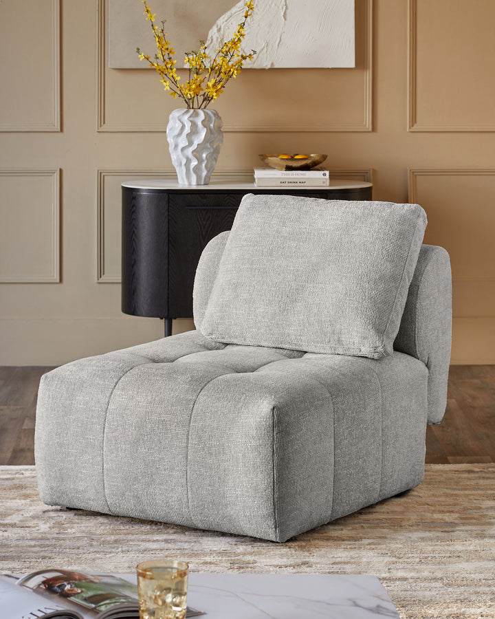 Lillian single-module sofa in light grey weave fabric, shown as a standalone chair with quilted seat and back cushion.