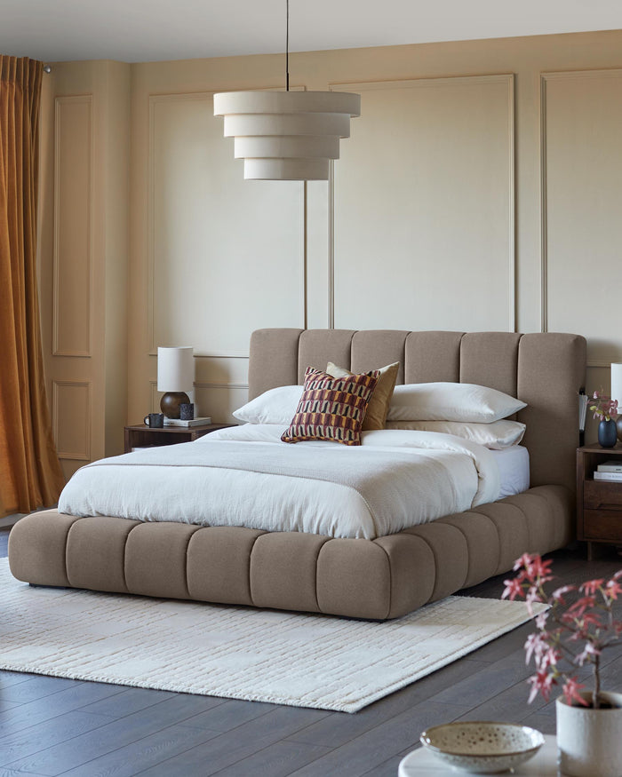Bedroom featuring a stylish, upholstered bed with a neutral colour palette. A bedside table and statement light complete the look.
