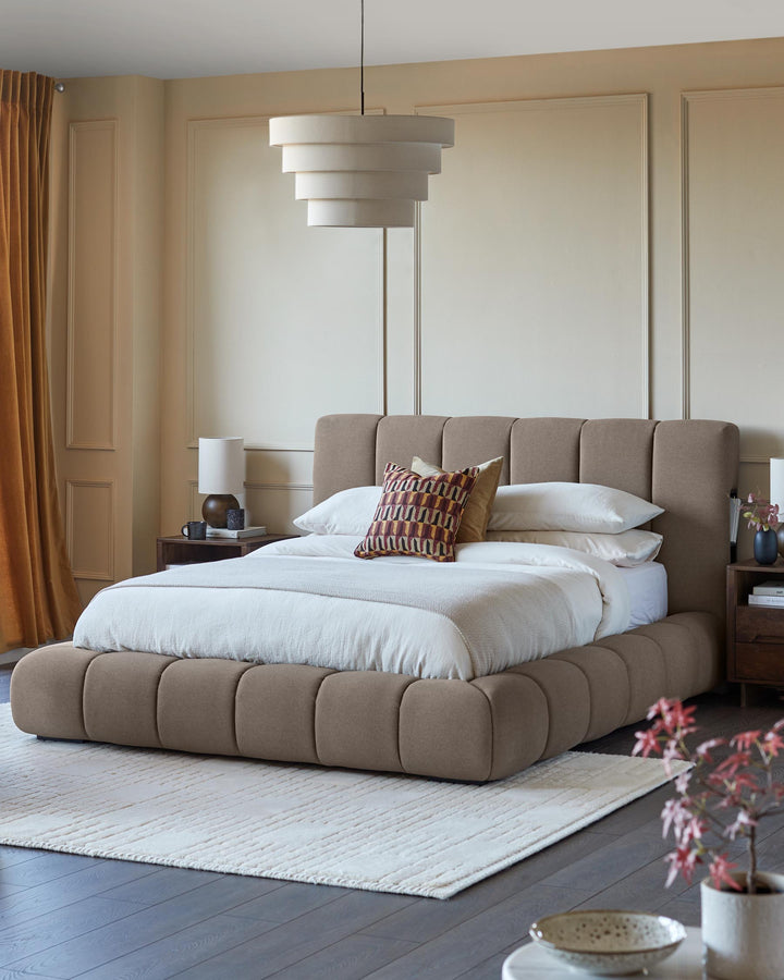 A stylish upholstered bed with a unique cubic design, complemented by modern side tables and a statement pendant light.