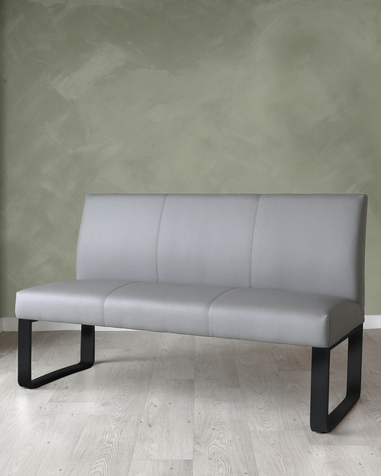Modern minimalist grey upholstered bench with a straight backrest and seamless seat design, supported by two U-shaped black metal legs.