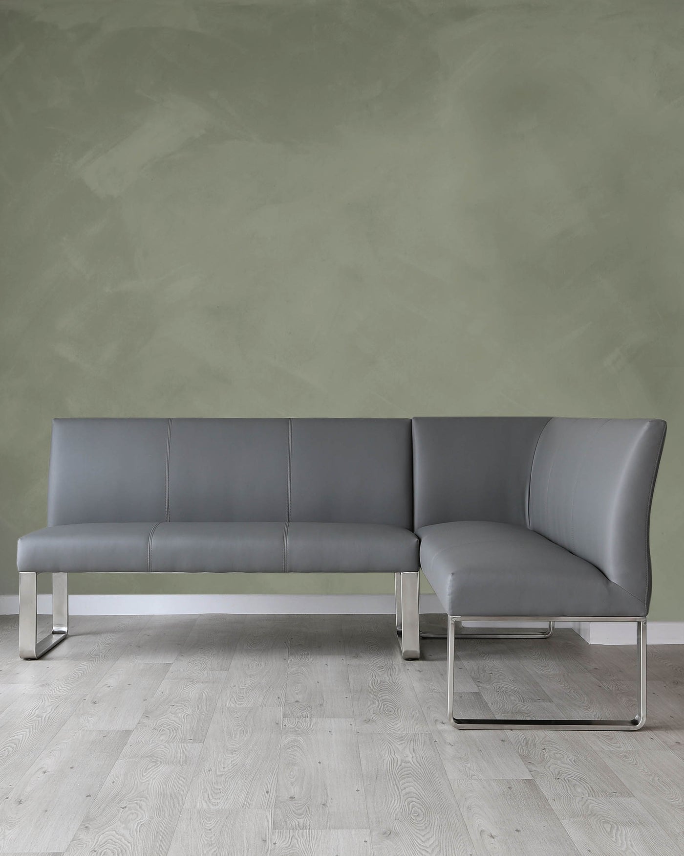Modern minimalist L-shaped sectional sofa with a sleek design, featuring grey upholstery and chrome metal legs.