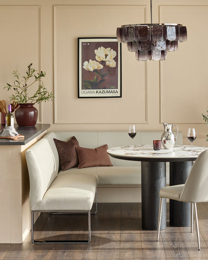 Light grey faux leather left-hand corner dining bench with chrome legs, shown in a styled dining room setting.