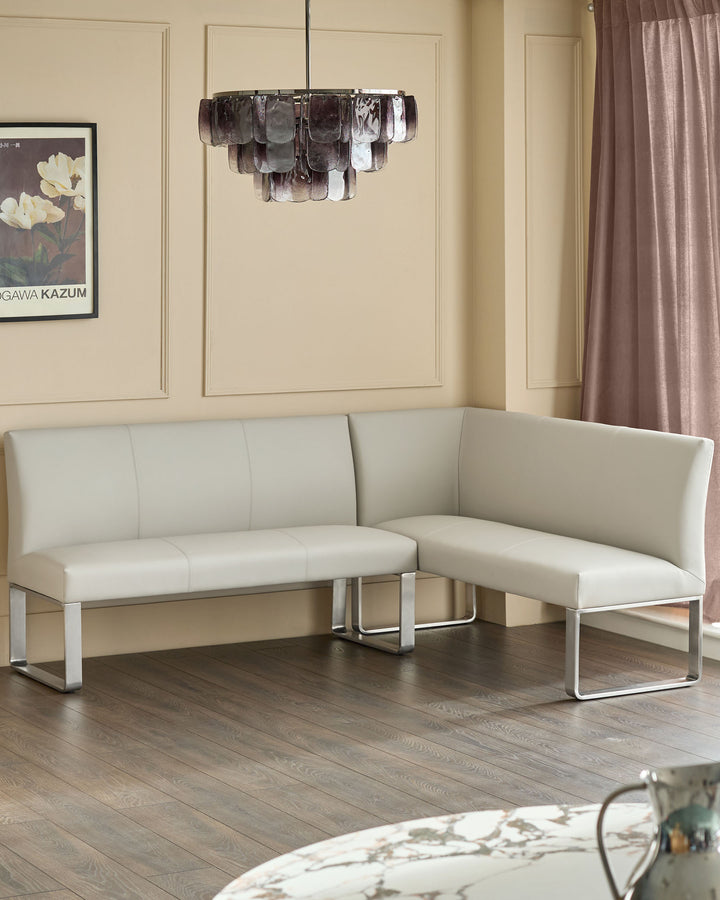 Light grey faux-leather left-hand corner bench with stainless steel frame, displayed in modern living room setting.