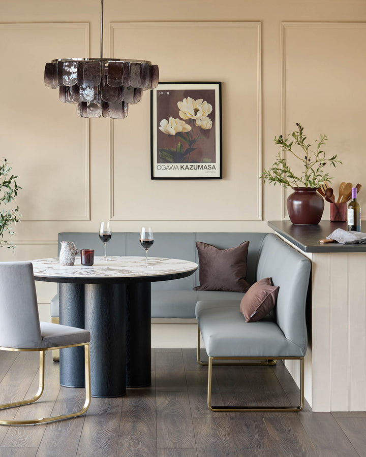 Loop 5-seater right-hand corner dining bench in mid-grey faux leather with brushed brass legs, shown in dining setting.