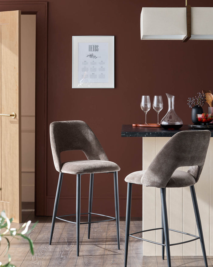 Stylish bar stools at a kitchen island with a sleek black countertop, perfect for modern homes.