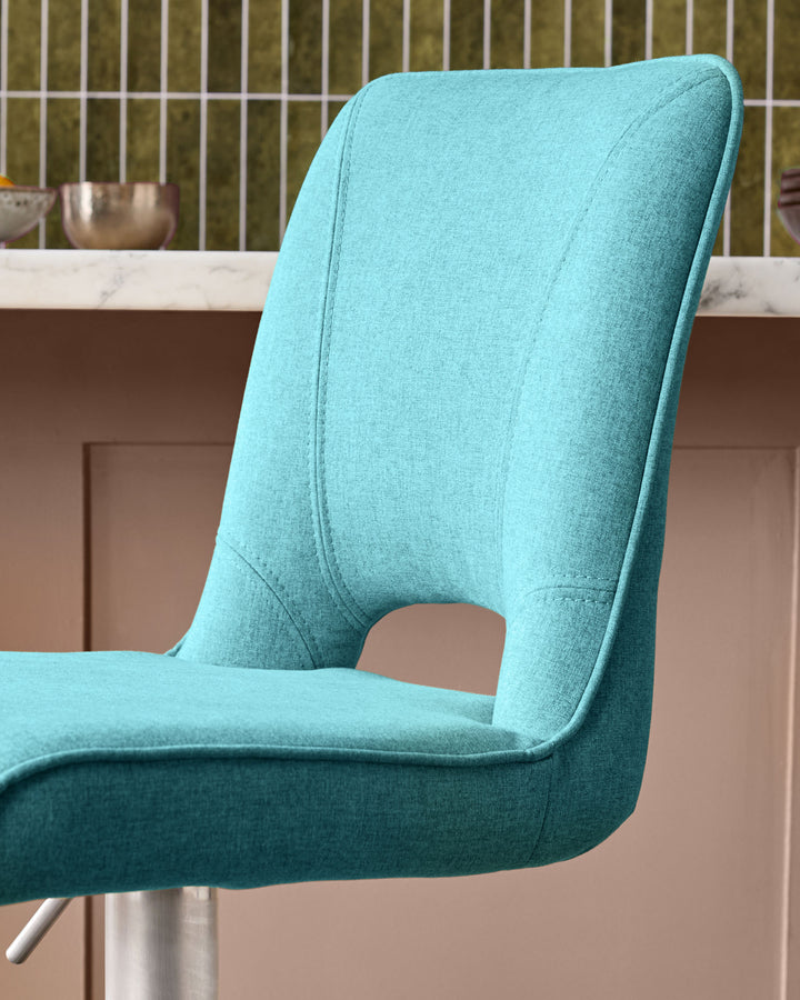 Light teal fabric gas lift bar stool with curved backrest and metal base, side view.