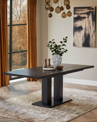 A dark wood dining table takes centre stage, complete with tableware, decorative vase and stylish modern lighting.