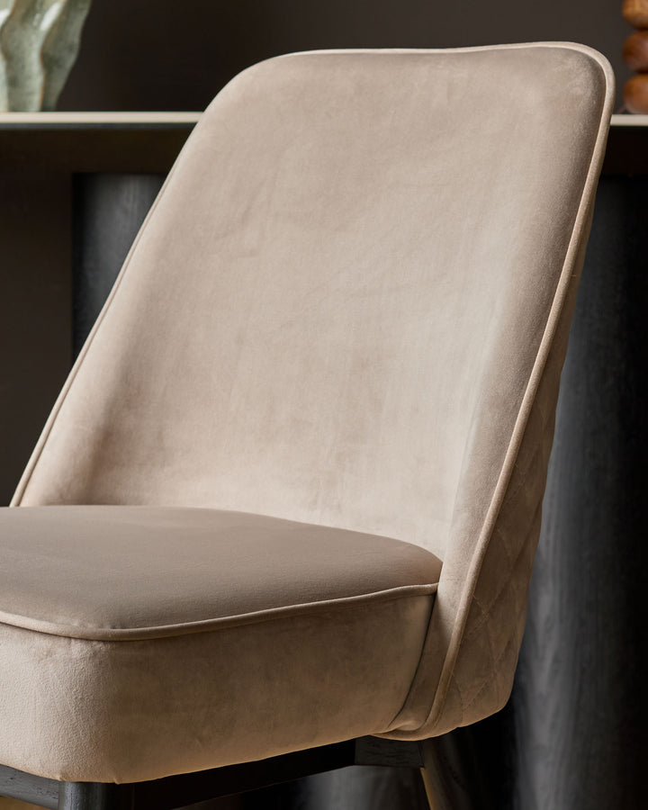 Mae Velvet Dining Chair in Champagne, side angle view showing curved backrest and upholstered seat.