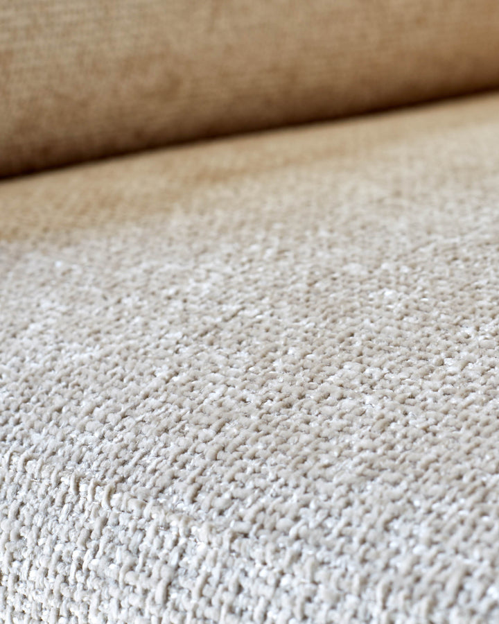 Close-up of a beige textured sofa, showing the fabric detail. A neutral colour with subtle texture.