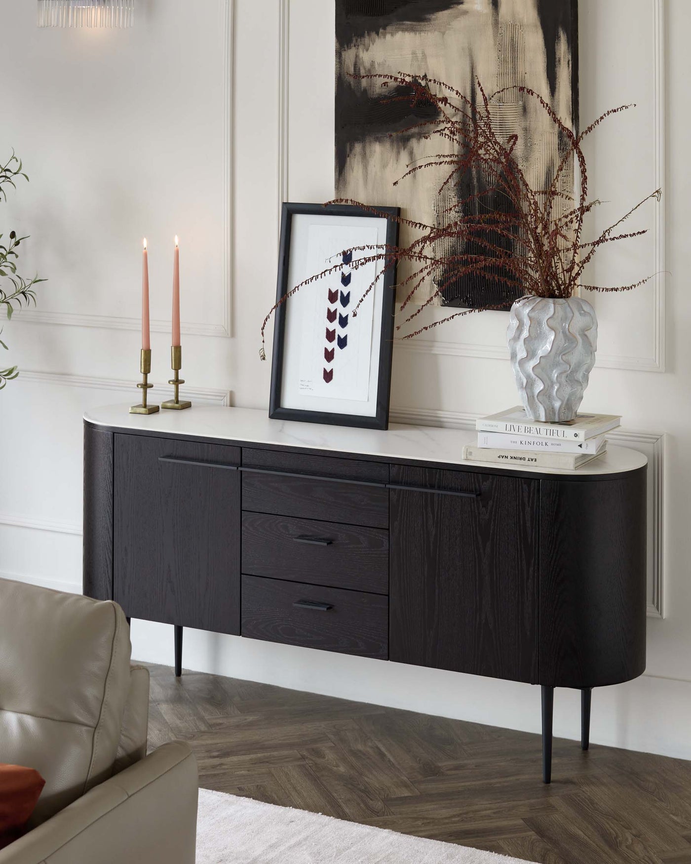 Elegant dark wood sideboard with a rounded silhouette and tapered metal legs, featuring a mix of cabinet doors and drawers for versatile storage.
