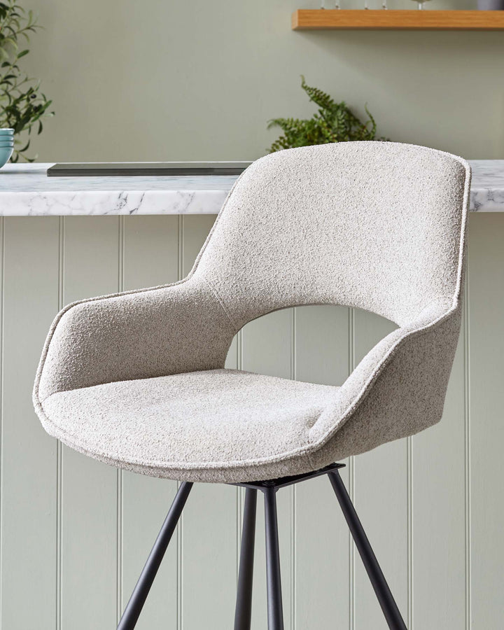 Modern upholstered chair with a smooth, curved silhouette, featuring a textured light beige fabric and a contrasting sleek black metal base with four splayed legs.