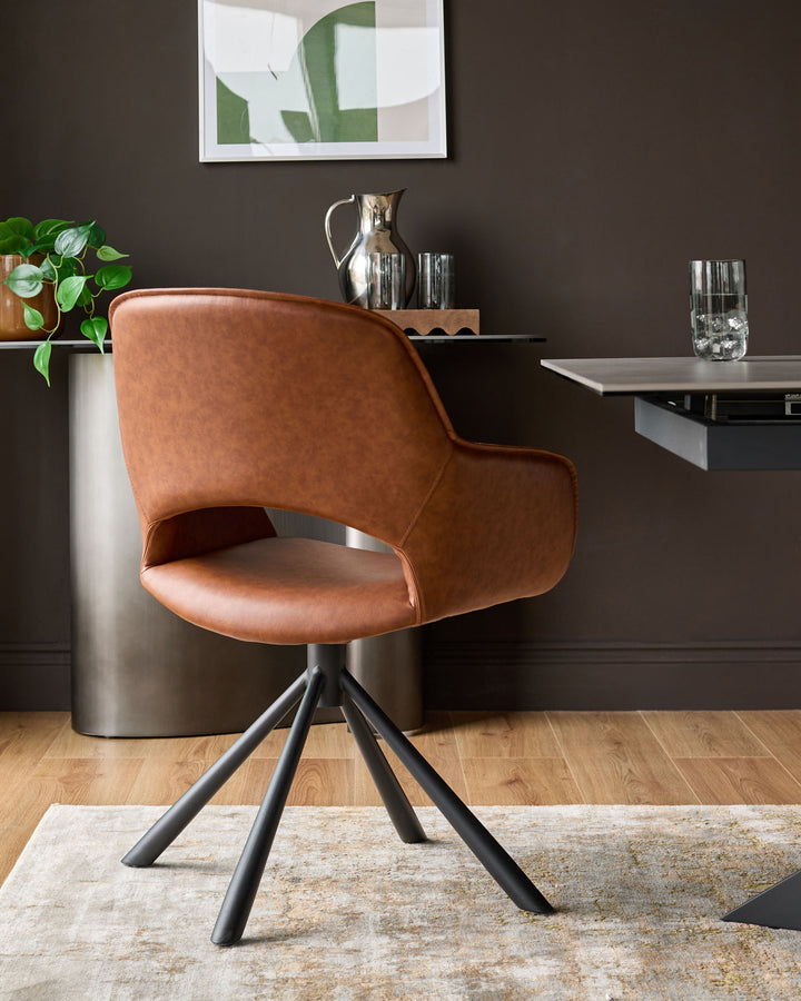 Tan leather swivel dining armchair with black metal four-leg base, shown in a styled interior setting.