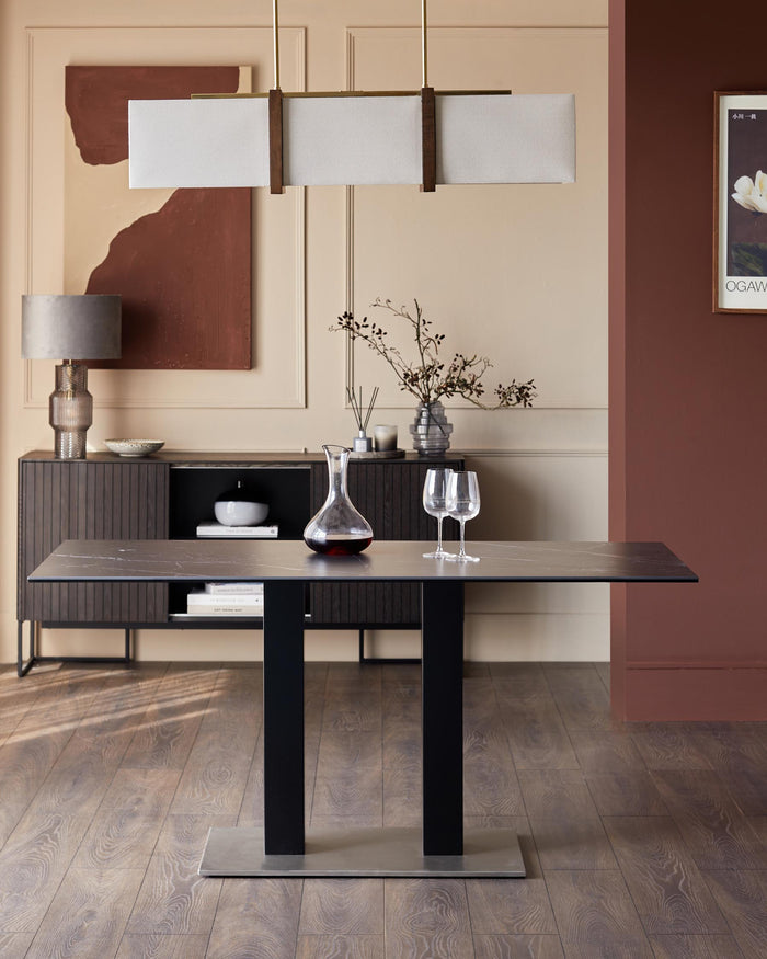 Stylish dining room with a modern dining table, sideboard, lamp, and decorative accessories.