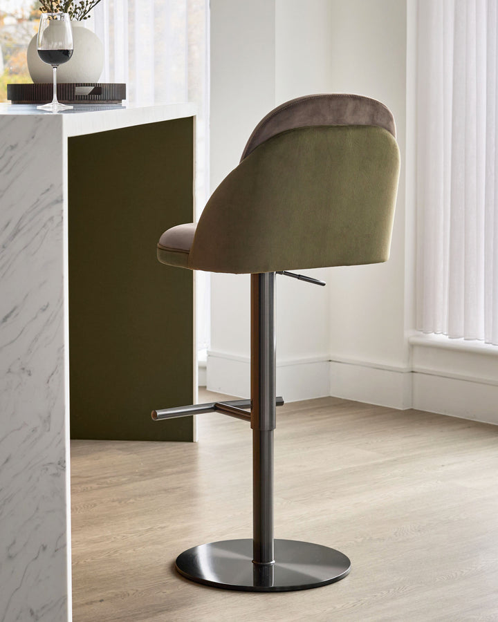 Myra gas lift bar stool in mocha and olive green velvet, shown from rear angle with chrome base and footrest.