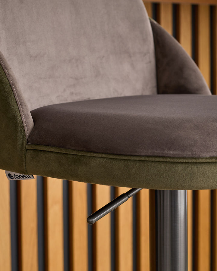Myra gas lift bar stool in mocha and olive green velvet with metal base, side view detail.