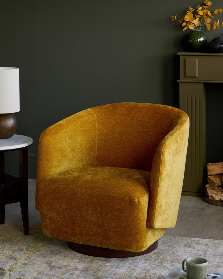 A plush, mustard-yellow swivel armchair adds warmth to this stylish living space featuring a side table and fireplace.