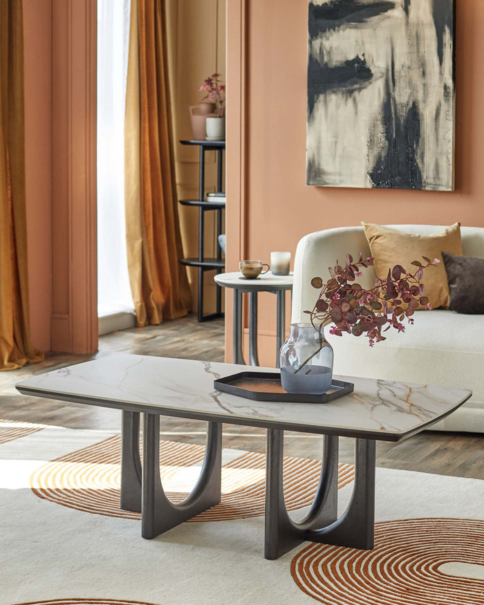 A stylish living room featuring a marble-topped coffee table, plush sofa, & modern art, creating a warm, inviting atmosphere.
