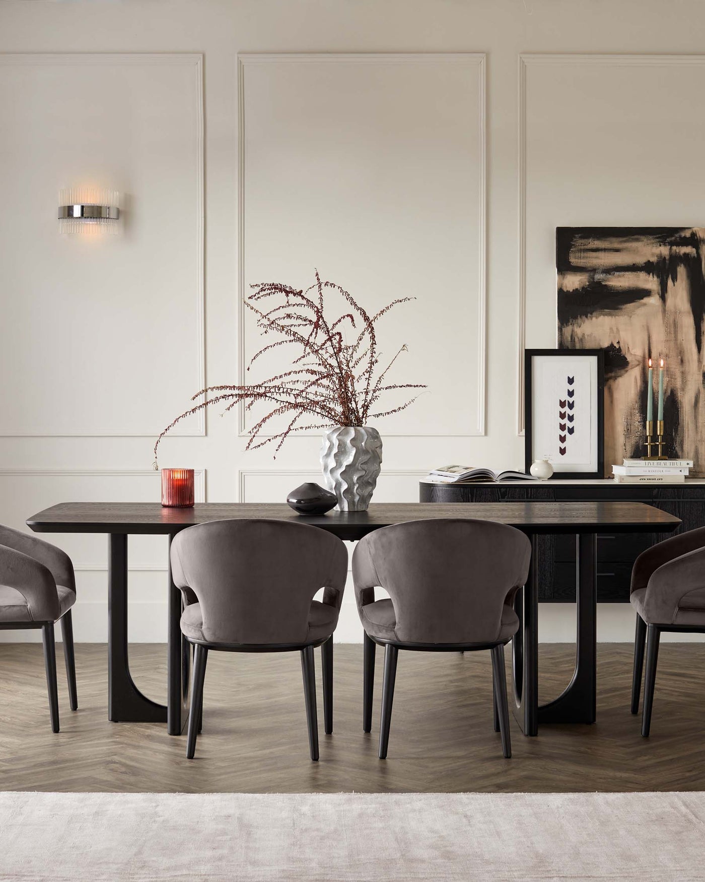 Modern minimalist dining room furniture set with a sleek, dark wood rectangular table and four plush, grey upholstered chairs with black legs, arranged on a subtle off-white area rug, creating a stylish and sophisticated interior.