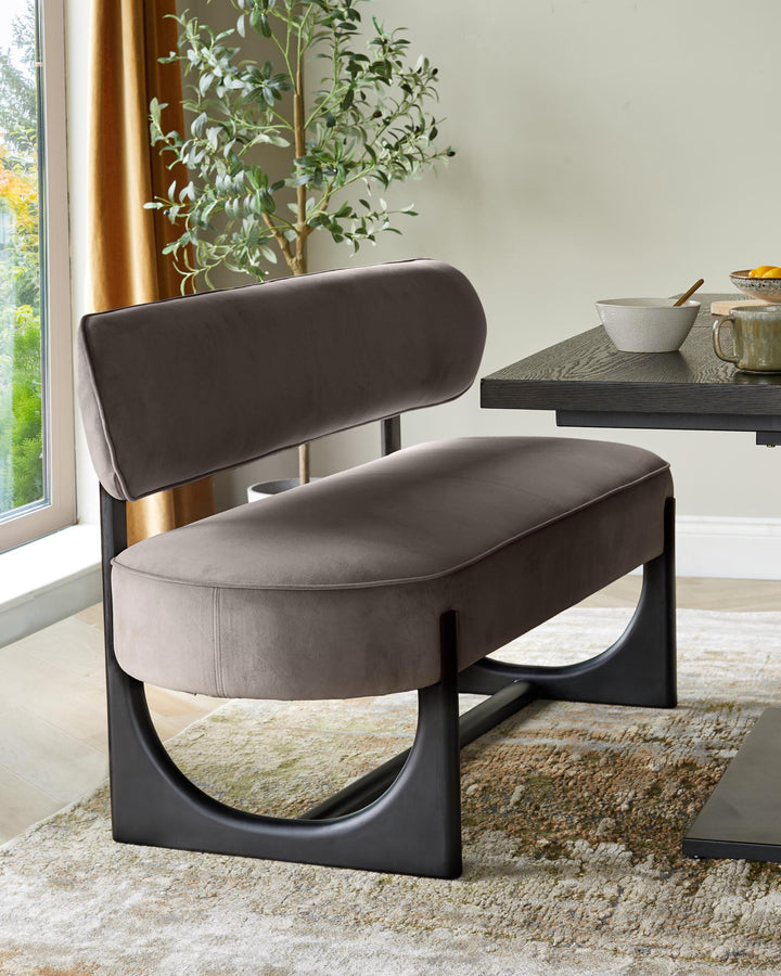 A stylish upholstered bench with a black frame complements a modern dining table in this inviting interior design.