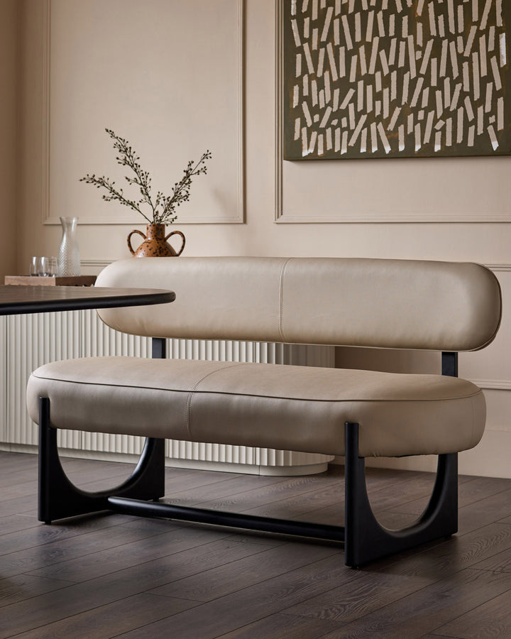 Orlan 3-seating dining bench with backrest in natural faux leather, featuring curved design and black wooden base.