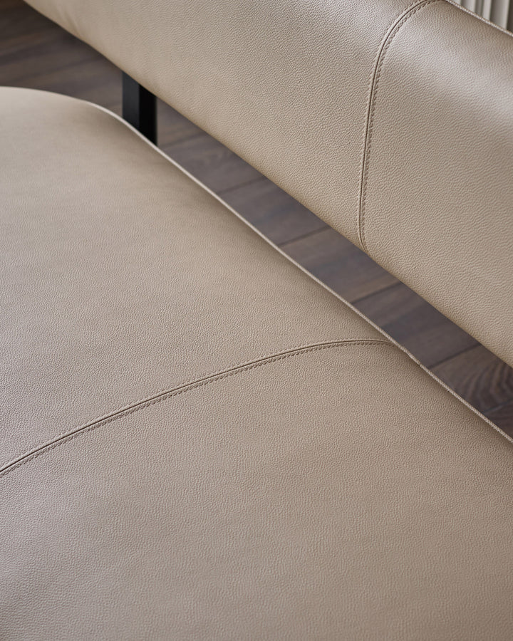 Cream faux leather bench with backrest, showing detailed stitching and dark metal trim accent.