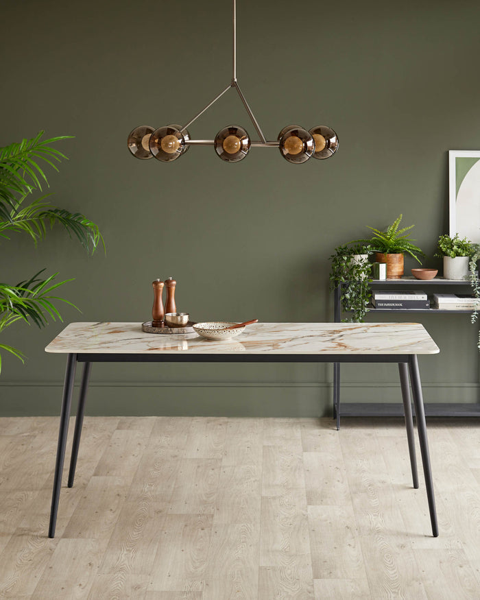 Dining room with table, black frame and marble-effect top. Display shelving and statement lighting add style.