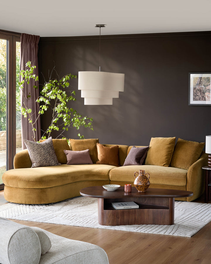 Ochre left-hand corner chaise sofa with curved arms and cushioned back, styled in a modern living room setting.