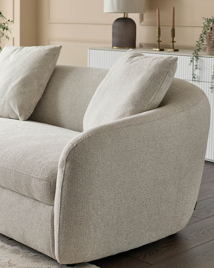 Ottilie left-hand corner chaise sofa in natural fabric with curved arms, angled view showing textured upholstery and cushions.