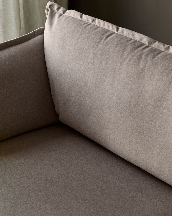 Otto 3-seater sofa in mocha fabric, showing cushioned seat and back with piping detail, side angle view.