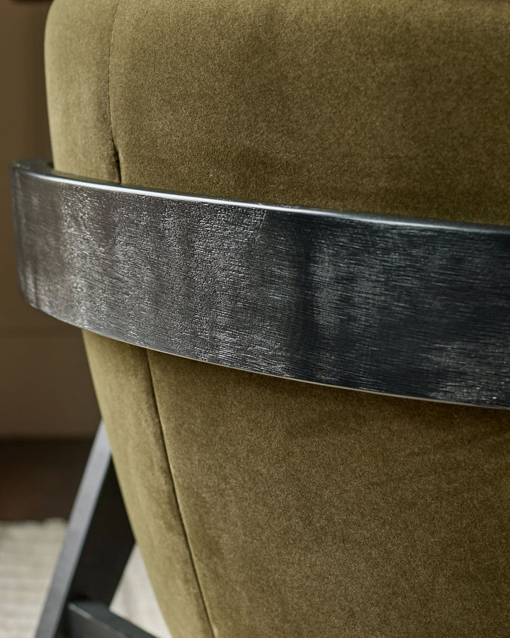 Palmer occasional chair in pistachio green fabric with brushed metal band detail, close-up side view.