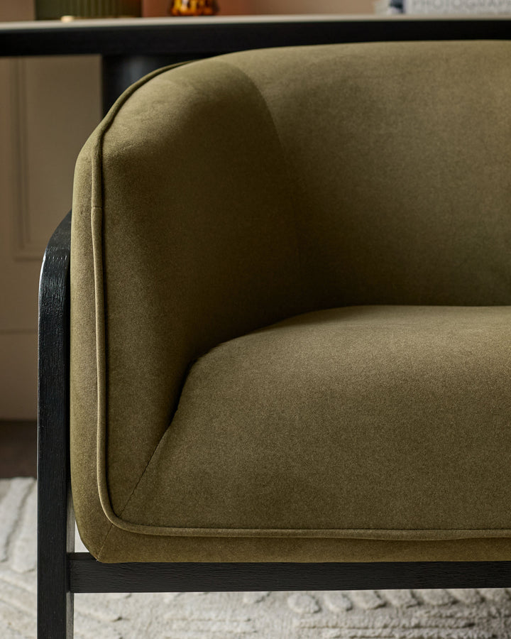 Palmer Occasional Chair in pistachio green fabric with curved armrests and black wooden frame, side detail view.