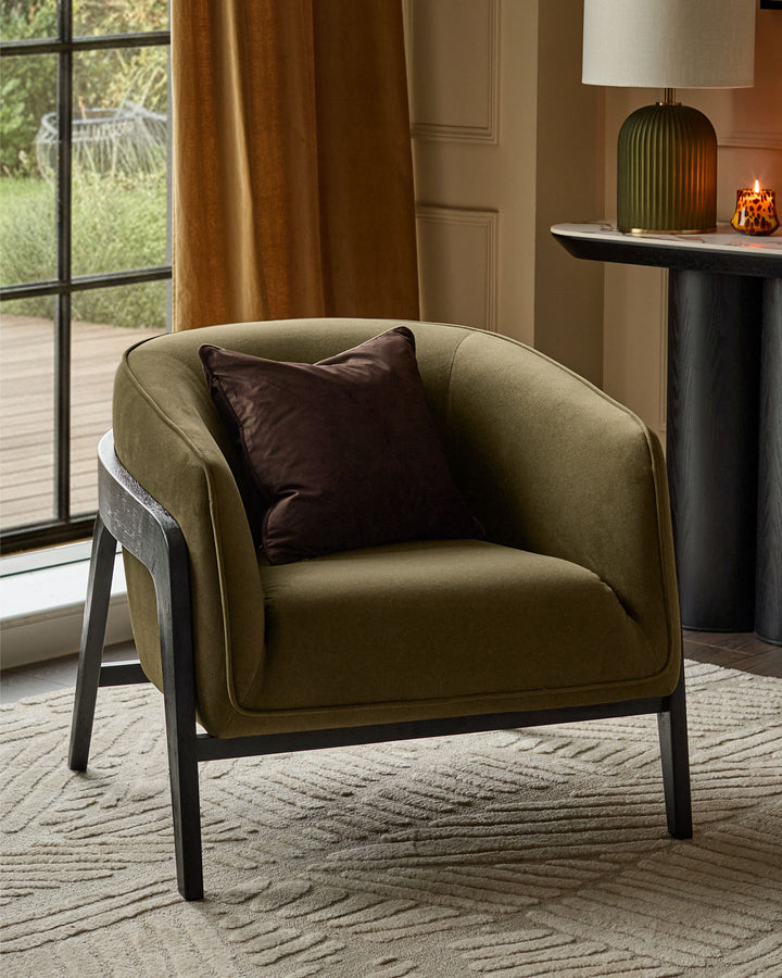 Palmer Occasional Chair in pistachio green fabric with dark wooden frame, featuring a brown accent pillow in a styled living room setting.