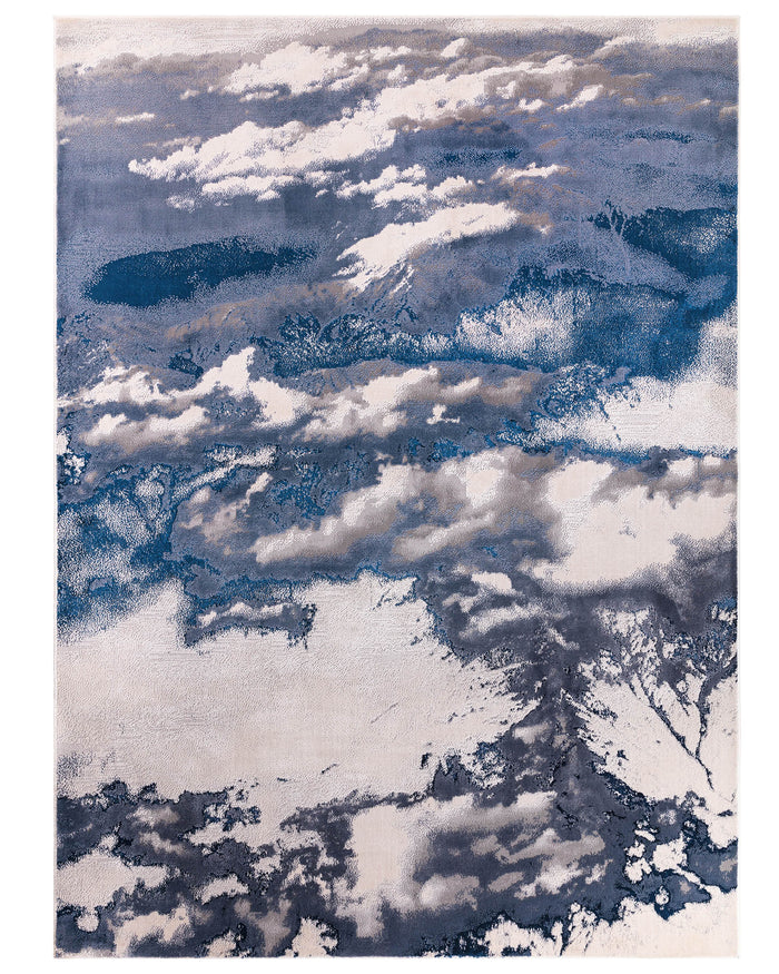 A modern rug with a cloud-like abstract design in shades of blue, grey and cream.