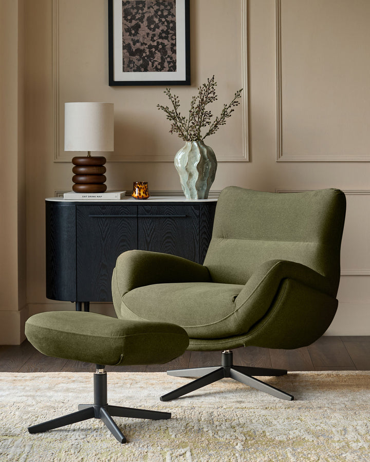 Olive green velvet Piper accent chair with matching footstool, featuring curved arms and black swivel base in room setting.