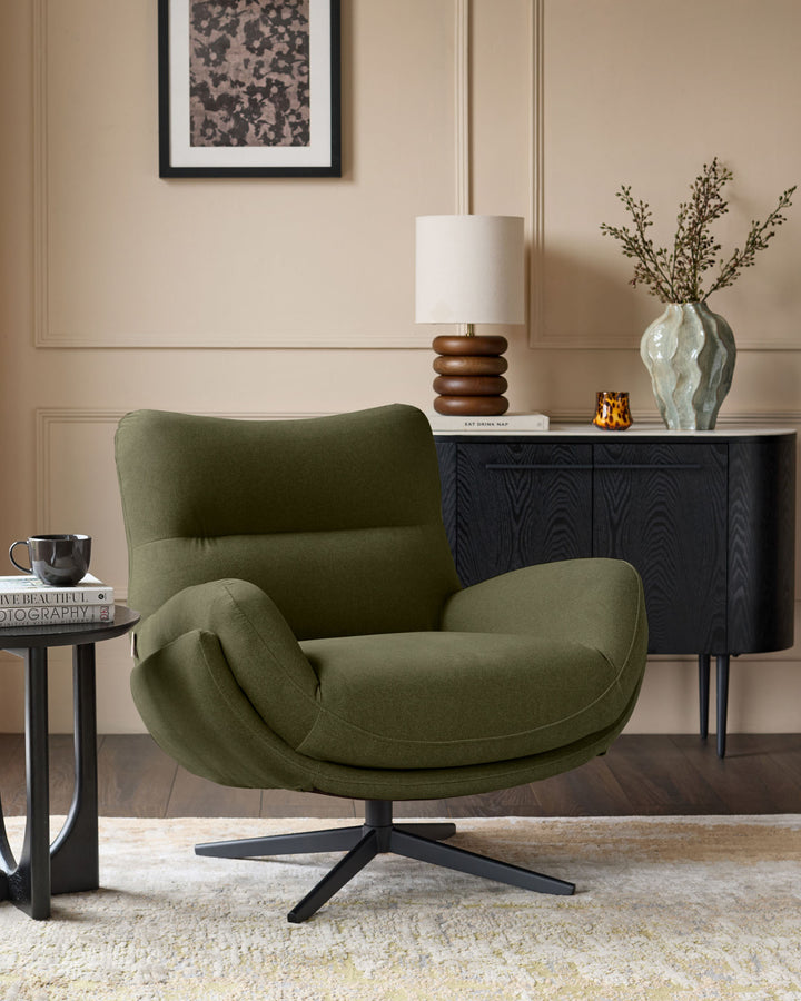 Piper accent chair in olive green velvet with black swivel base, shown in styled living room setting.
