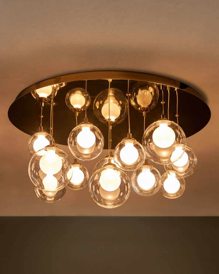 A ceiling light featuring glass bulbs hanging from a gold-coloured base. It's stylish and modern, providing ambient light.