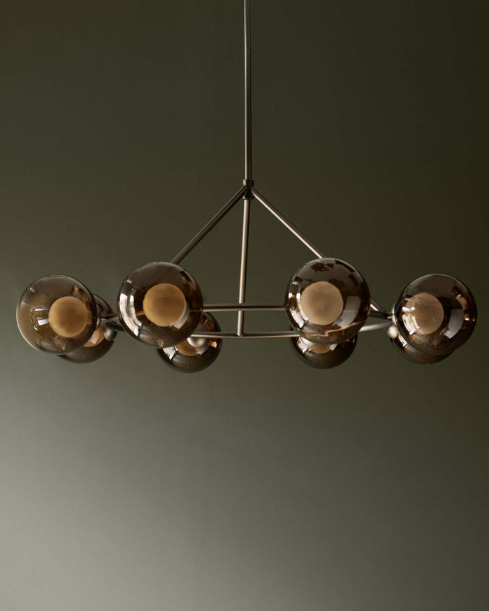 A modern chandelier with smoked glass globes and a sleek, metallic frame, adding a touch of sophistication to any room.