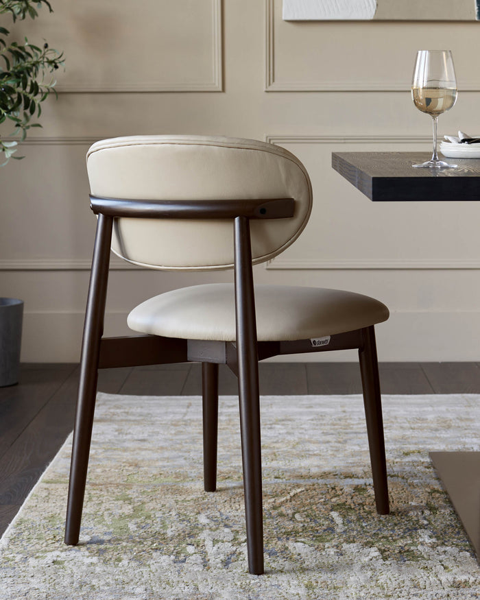 A stylish, modern dining chair with a cream leather seat and back, and dark wooden legs.