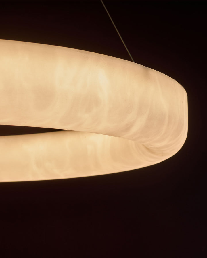 Sadie Large Pendant Light in alabaster effect natural finish, showing curved dome shape against dark background.